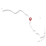 Map outline of Florida with a pin marking a specific location on the west coast, indicating a point of interest.